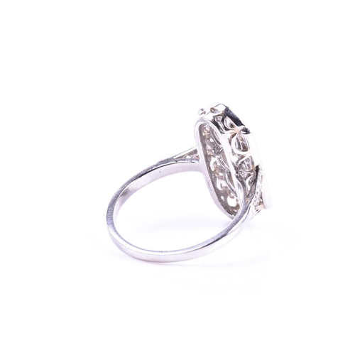 629 - A platinum and diamond ring, in the Art Deco style, the lozenge-shaped plaque ring inset with three ... 