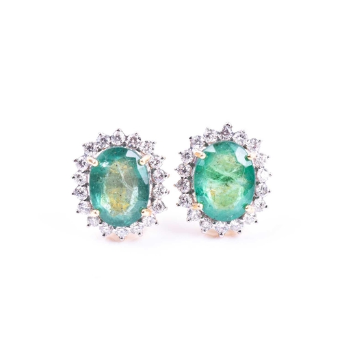 636 - A pair of diamond and emerald cluster earrings, set with mixed oval-cut emeralds of approximately 5.... 