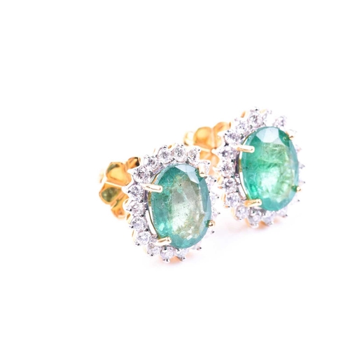 636 - A pair of diamond and emerald cluster earrings, set with mixed oval-cut emeralds of approximately 5.... 