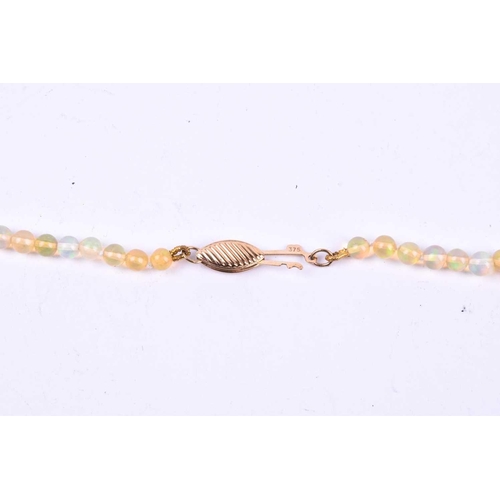 640 - A graduated opal bead necklace, the round beads measuring approximately 5 x 3 mm, fastened with a 9c... 