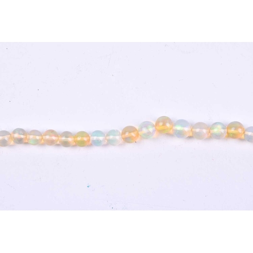 640 - A graduated opal bead necklace, the round beads measuring approximately 5 x 3 mm, fastened with a 9c... 