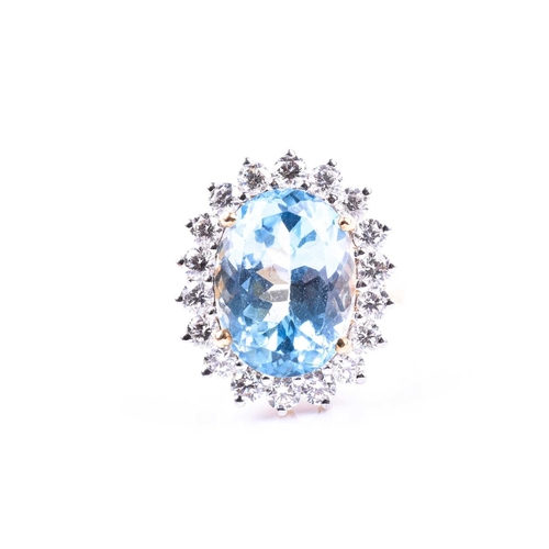 643 - An 18ct yellow gold, diamond, and blue topaz cocktail ring, set with a mixed oval-cut topaz of appro... 