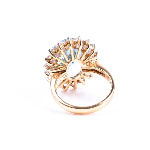 643 - An 18ct yellow gold, diamond, and blue topaz cocktail ring, set with a mixed oval-cut topaz of appro... 