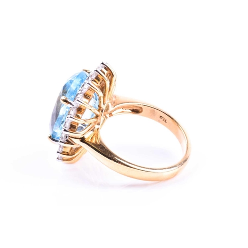 643 - An 18ct yellow gold, diamond, and blue topaz cocktail ring, set with a mixed oval-cut topaz of appro... 