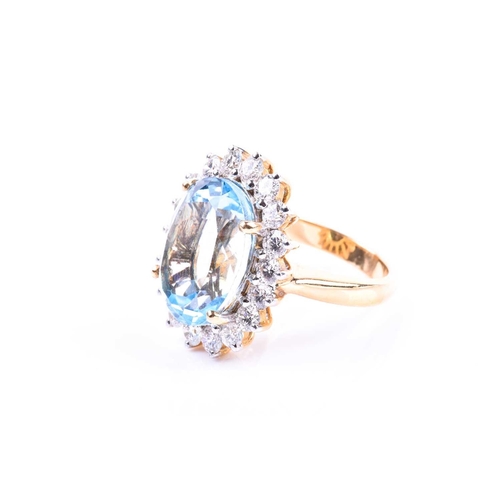 643 - An 18ct yellow gold, diamond, and blue topaz cocktail ring, set with a mixed oval-cut topaz of appro... 