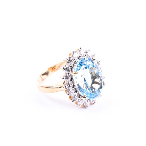 643 - An 18ct yellow gold, diamond, and blue topaz cocktail ring, set with a mixed oval-cut topaz of appro... 