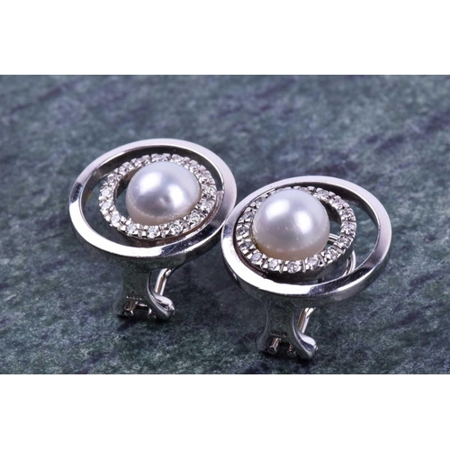 647 - A pair of 14ct white gold, diamond, and pearl earrings of circular form, designed as concentric circ... 