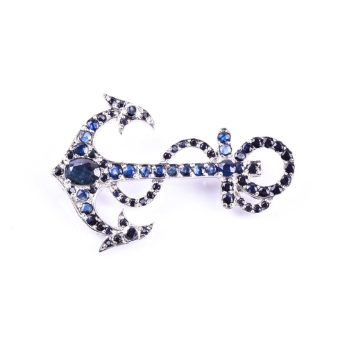 656 - A silver and sapphire anchor brooch, set with mixed round- and oval-cut sapphires, marked 925 to ver... 