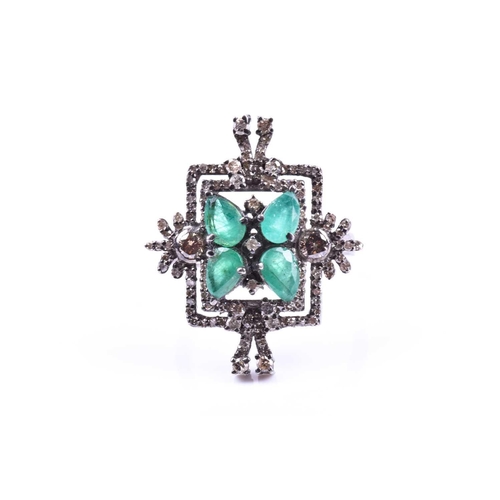 657 - An unusual silver, diamond, and emerald cocktail ring, set with four pear-cut emeralds in a butterfl... 