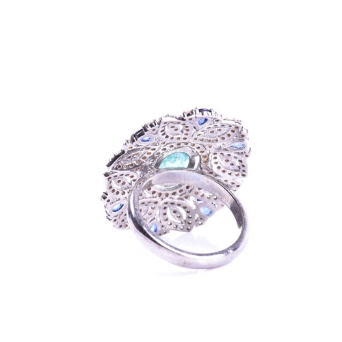 663 - An impressive diamond and emerald cocktail ring, set with a mixed oval-cut emerald within an openwor... 