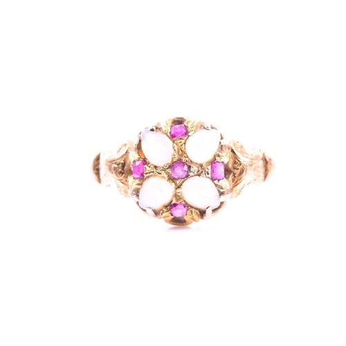 664 - A Victorian yellow gold, opal, and ruby cluster ring with stylised and engraved decoration to should... 