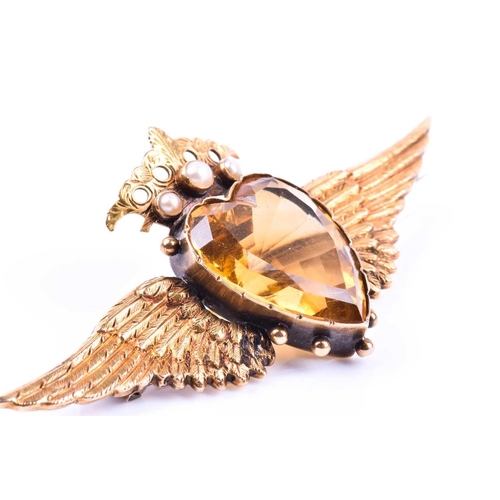 666 - A yellow metal, citrine, and pearl brooch, set with a heart-shaped citrine, surmounted with a crown ... 