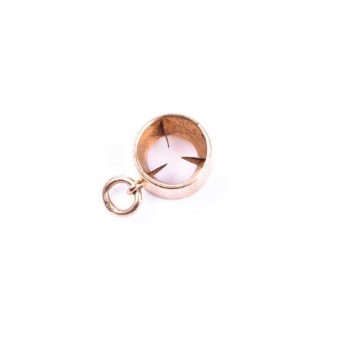 669 - Asprey & Co. An unusual novelty 9ct yellow gold pendant in the form of a small cigar cutter, 12 mm d... 