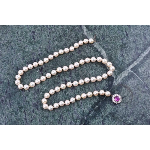 670 - A cultured pearl necklace, individually knotted pearls, approximately 6 mm diameter, fastened with a... 