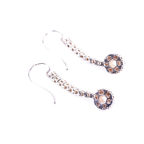 686 - A pair of diamond drop earrings, set with round brilliant-cut diamond clusters beneath a vertical ar... 