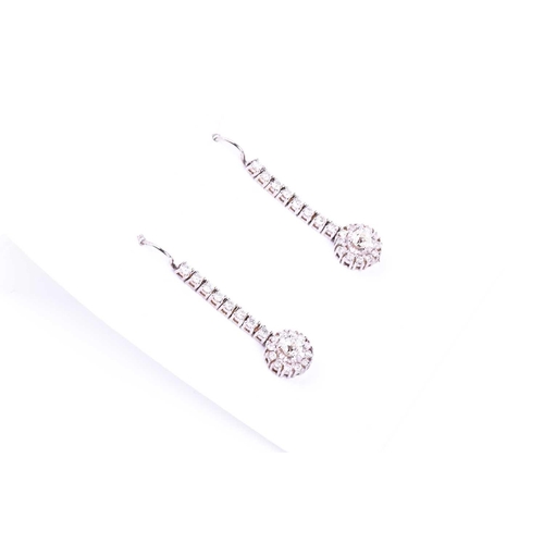 686 - A pair of diamond drop earrings, set with round brilliant-cut diamond clusters beneath a vertical ar... 