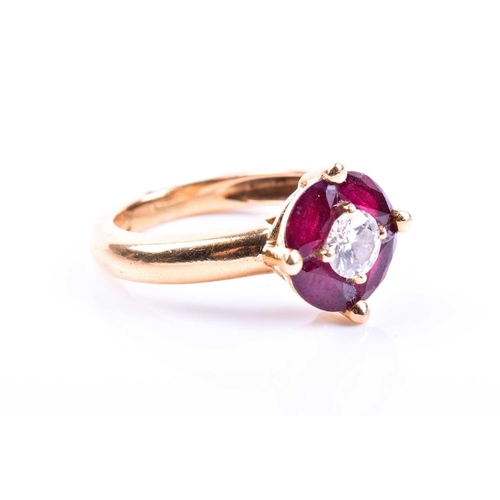 691 - A Continental yellow gold, diamond, and ruby cluster ring, set with a round brilliant-cut diamond of... 