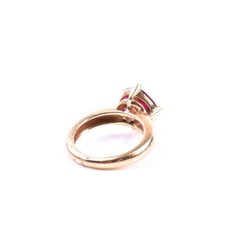 691 - A Continental yellow gold, diamond, and ruby cluster ring, set with a round brilliant-cut diamond of... 