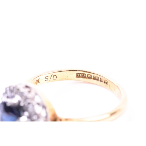 692 - An 18ct yellow gold, diamond, and sapphire cluster ring, set with a round-cut sapphire, surrounded w... 