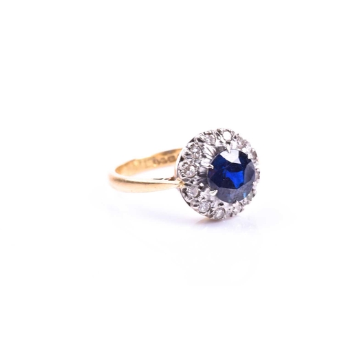 692 - An 18ct yellow gold, diamond, and sapphire cluster ring, set with a round-cut sapphire, surrounded w... 