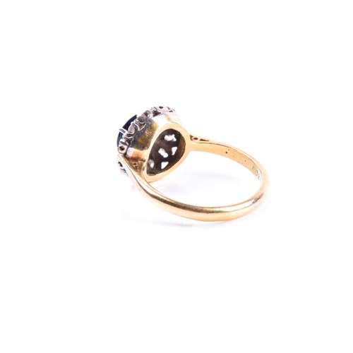 692 - An 18ct yellow gold, diamond, and sapphire cluster ring, set with a round-cut sapphire, surrounded w... 