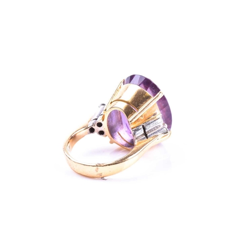 694 - An 18ct yellow gold, diamond, and amethyst cocktail ring, set with a large mixed oval-cut amethyst, ... 