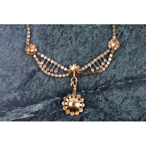 707 - A late 19th / early 20th century yellow gold and pearl floral cluster drop necklace, set with seed p... 