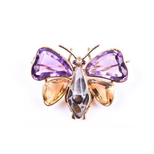 710 - An amethyst and citrine butterfly brooch, the yellow metal mount set with mixed-cut gemstone wings, ... 