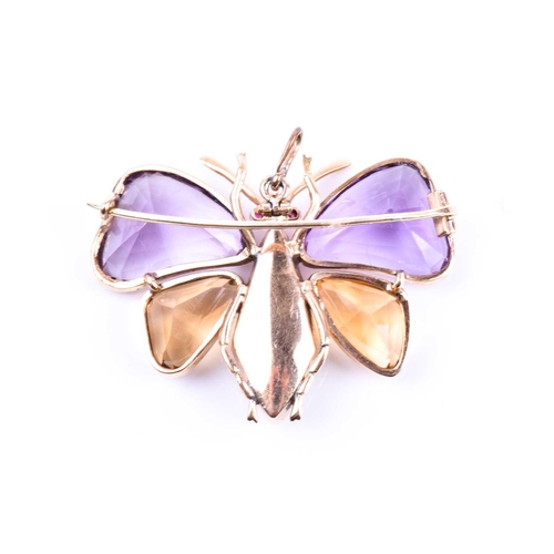 710 - An amethyst and citrine butterfly brooch, the yellow metal mount set with mixed-cut gemstone wings, ... 