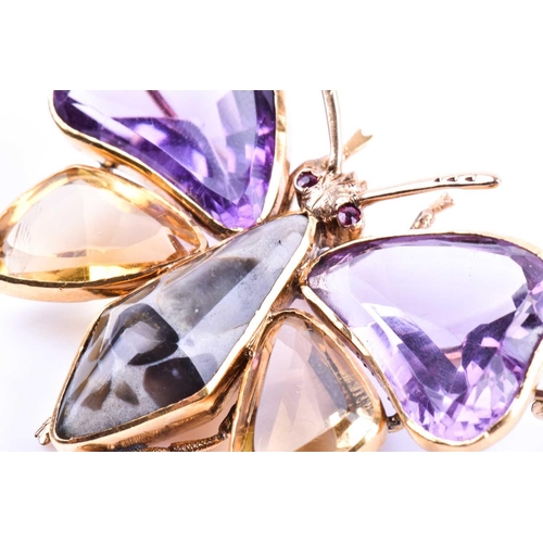 710 - An amethyst and citrine butterfly brooch, the yellow metal mount set with mixed-cut gemstone wings, ... 