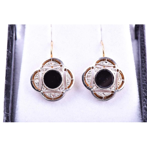 713 - A pair of Art Deco diamond and onyx earrings, of quatrefoil design, each inset with a round onyx pla... 