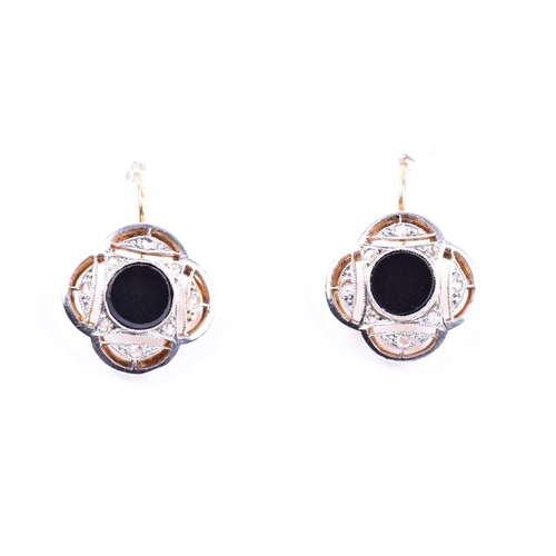 713 - A pair of Art Deco diamond and onyx earrings, of quatrefoil design, each inset with a round onyx pla... 