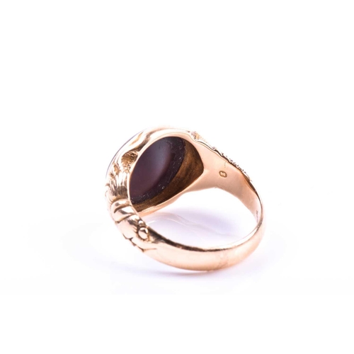 715 - A 15ct yellow gold and onyx Masonic ring, set with a round hardstone plaque depicting the Masonic co... 