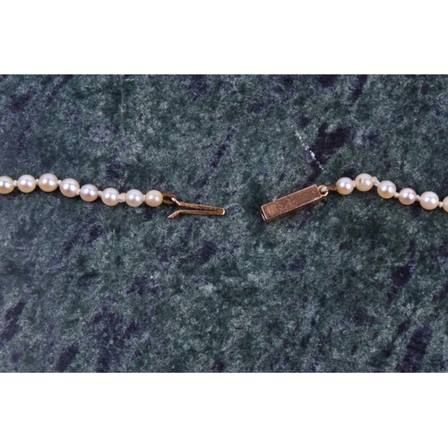 722 - A graduated cultured pearl necklace, the white pearls measuring approximately 3-6 mm, fastened with ... 