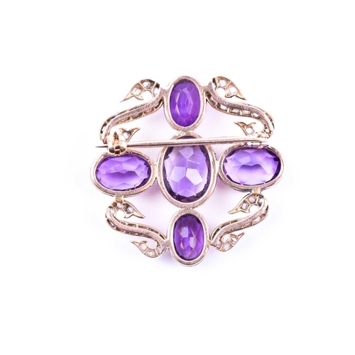 724 - A diamond and amethyst brooch, set with four mixed oval-cut amethysts in a cross design, with four s... 