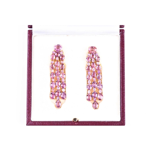 726 - A pair of pink tourmaline drop earrings, each set with mixed round- and oval-cut pink tourmalines, i... 