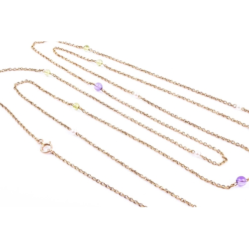 727 - An opera-length yellow gold, amethyst, peridot, and pearl necklace, the long chain set with amethyst... 