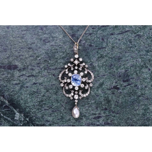 729 - An impressive diamond, sapphire, and pearl pendant, the openwork mount centred with a cushion-cut Ce... 