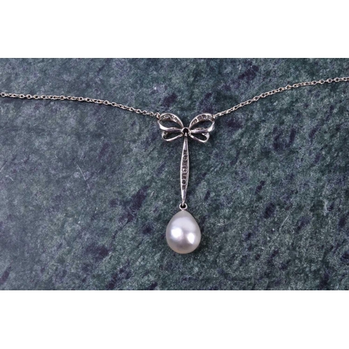 730 - A diamond and pearl drop pendant necklace, the diamond-set bow-shaped mount suspended with a vertica... 