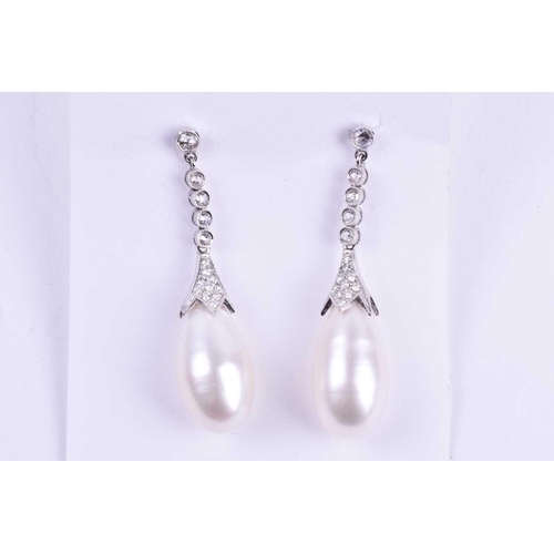 731 - A pair of diamond and pearl drop earrings, each with an elongated cultured pearl, set in a diamond-s... 