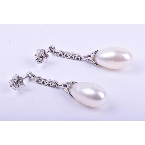 731 - A pair of diamond and pearl drop earrings, each with an elongated cultured pearl, set in a diamond-s... 