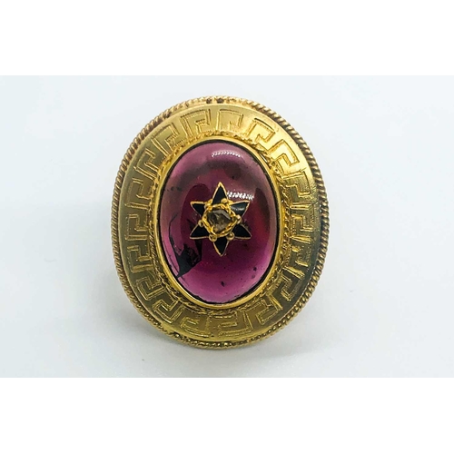 736 - A yellow gold and garnet ring, centred with an oval cabochon garnet, inset with rose-cut diamond and... 