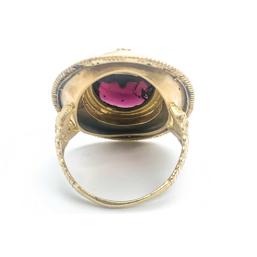 736 - A yellow gold and garnet ring, centred with an oval cabochon garnet, inset with rose-cut diamond and... 