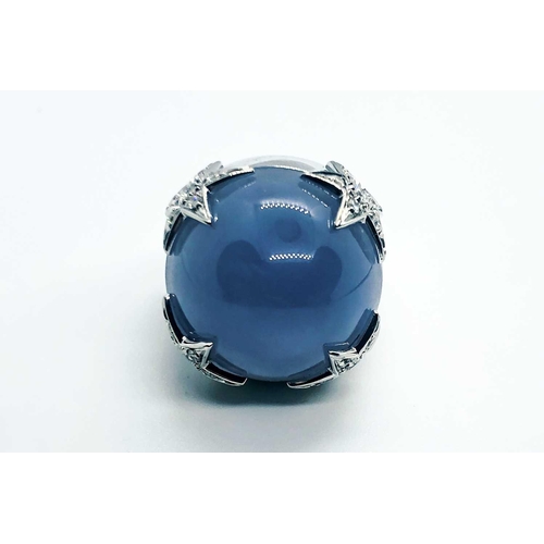 738 - Margherita Burgener. An 18ct white gold, diamond and chalcedony ring set with a round cabochon blue ... 