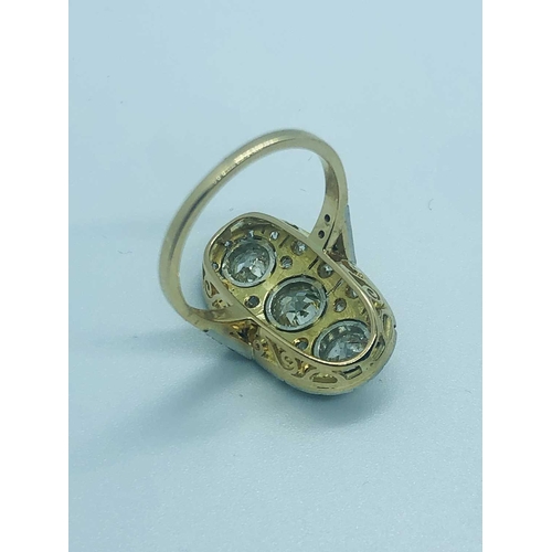 739 - An 18ct gold and diamond ring, of oval plaque design, centered with a row of three collet-set round ... 