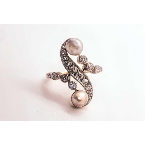 740 - A diamond and pearl scroll ring, set with a silver pearl and a gold pearl, and small old-cut diamond... 