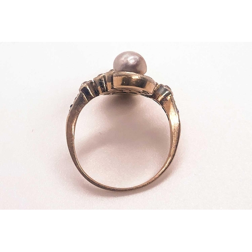 740 - A diamond and pearl scroll ring, set with a silver pearl and a gold pearl, and small old-cut diamond... 