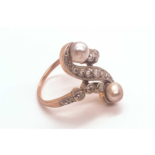 740 - A diamond and pearl scroll ring, set with a silver pearl and a gold pearl, and small old-cut diamond... 