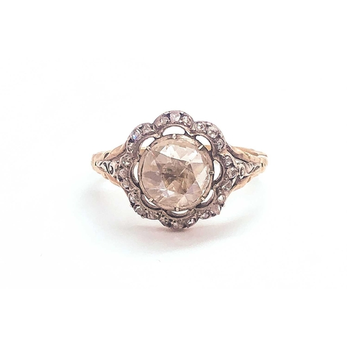 741 - A diamond cluster ring, centred with a rose-cut diamond of approximately 1.04 carats, within a flora... 