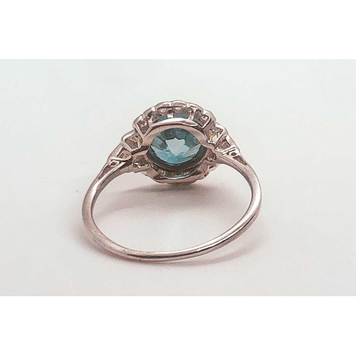 743 - A diamond and blue zircon ring, set with a natural zircon of approximately 2.54 carats, within a bor... 